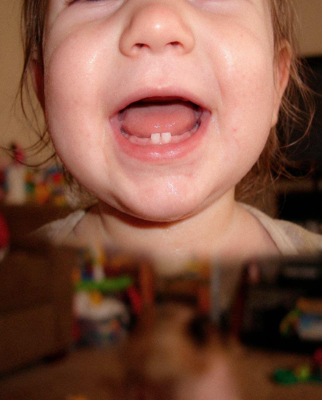 Baby smiling, showing two new front teeth